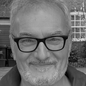 Black and white photograph of author Peter Bently, a middle aged white man wearing glasses.