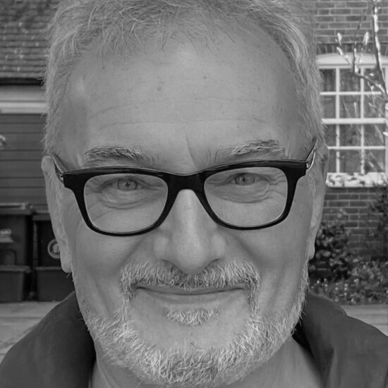 Black and white photograph of author Peter Bently, a middle aged white man wearing glasses.