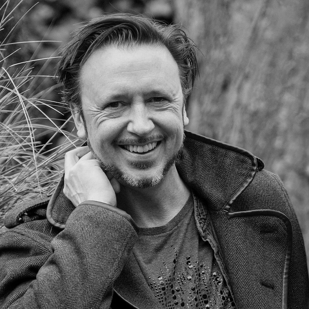 Black and white photograph of author Steve Cole, a middle aged white man with a beard.