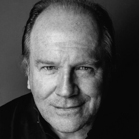 Black and white photograph of author William Boyd, a middle aged white man.