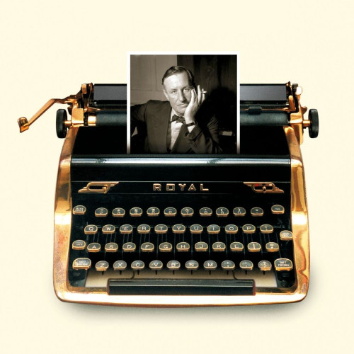 Photograph of Ian Fleming's golden typewriter taken from the cover of the book The Man With The Golden Typewriter. The image shows a gold metal typewriter with an image of Ian Fleming coming out of the roller.